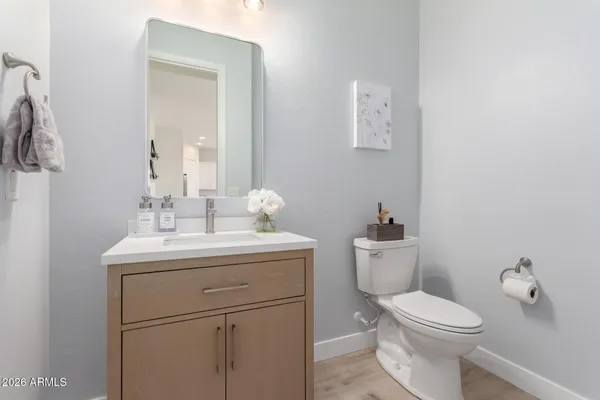 a bathroom with a toilet a sink and mirror