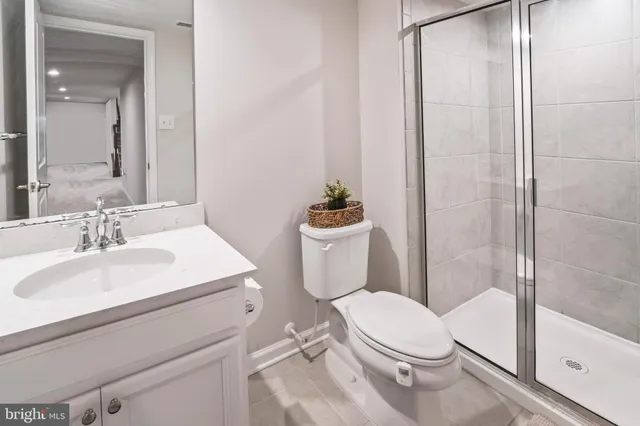 a white toilet sitting next to a bathroom sink