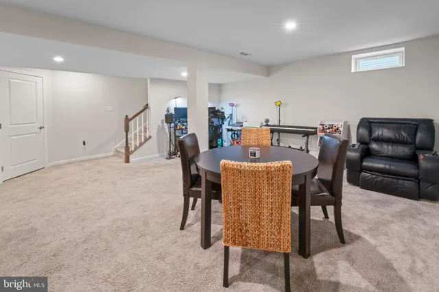 a dining room with furniture and wooden floor