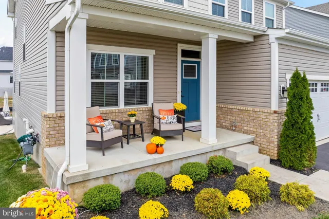 a front view of a house with a yard and patio
