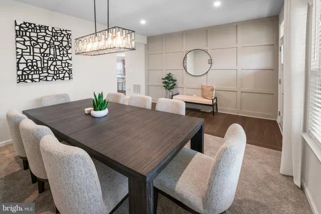 a dining room with furniture and wooden floor