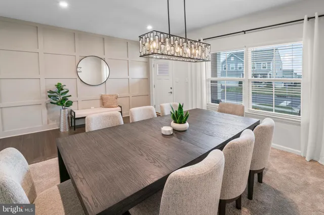 a view of a dining room with furniture a chandelier and wooden floor