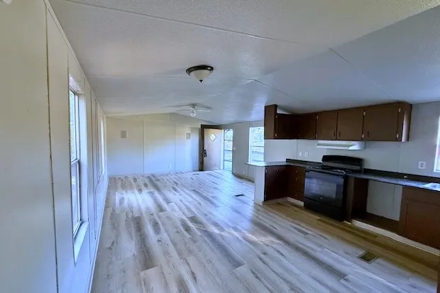 a kitchen with granite countertop wooden floors and stainless steel appliances