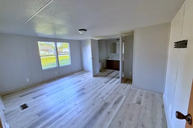 wooden floor in an empty room with a window