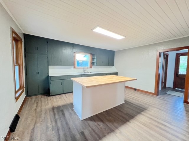1918 Wainwright Road New Philadelphia, OH 44663 - Photo 5 of 24 Kitchen with sink, light hardwood / wood-style floors, a kitchen island, and wooden counters