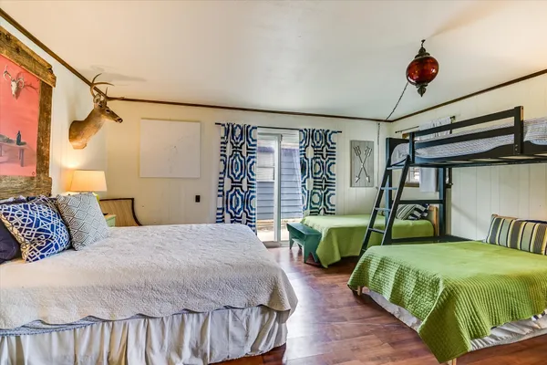a bedroom with two beds and a chandelier