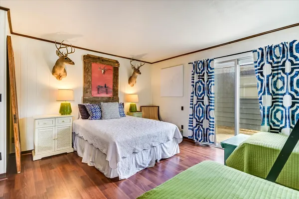 a bedroom with a bed window and a chair
