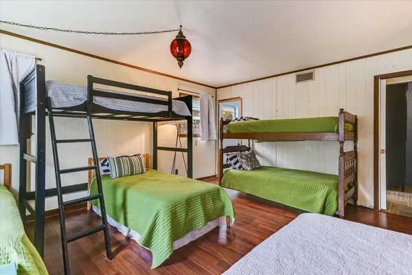 a bedroom with two beds and a table