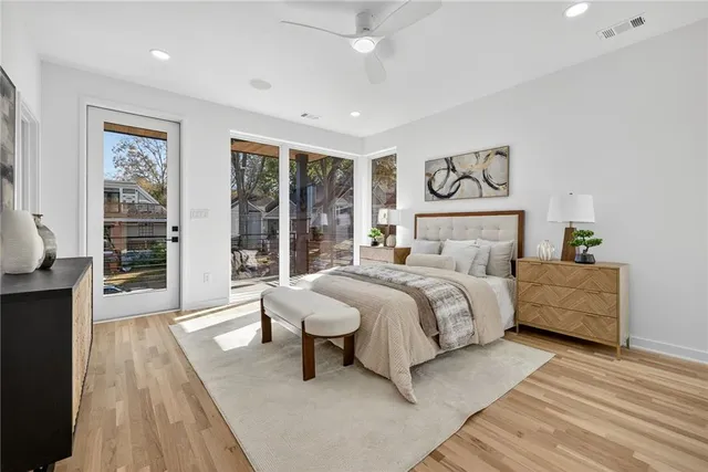 a bedroom with a bed and wooden floor