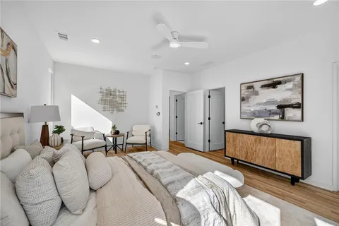 a bedroom with furniture and wooden floor