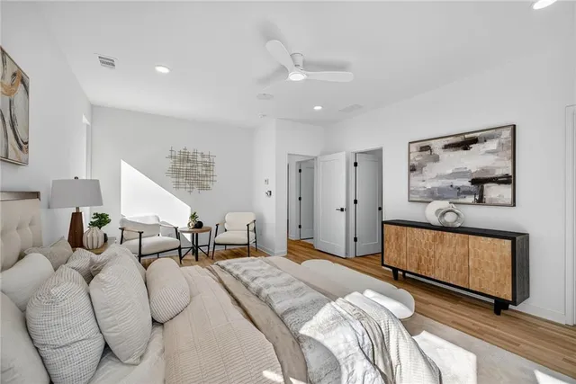 a bedroom with furniture and wooden floor