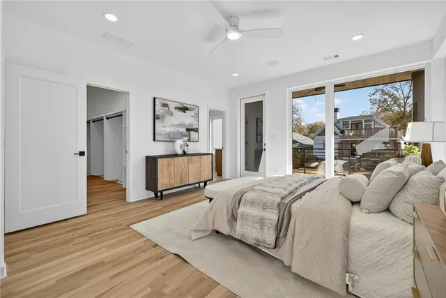 a bedroom with a large bed and a large window