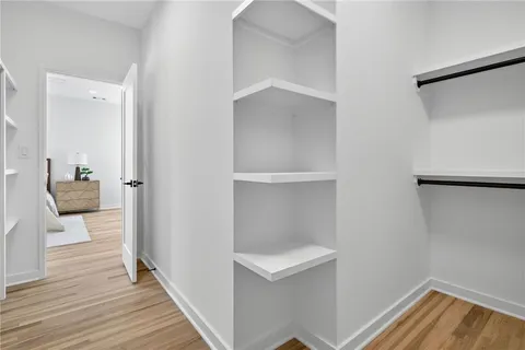 a view of a hallway view with wooden floor and staircase