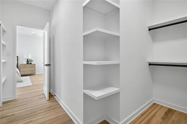 a view of a hallway view with wooden floor and staircase