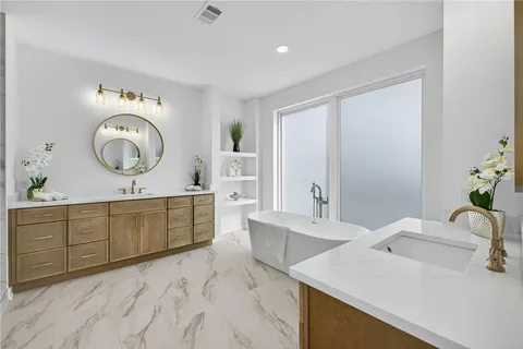 a spacious bathroom with a granite countertop sink and a mirror