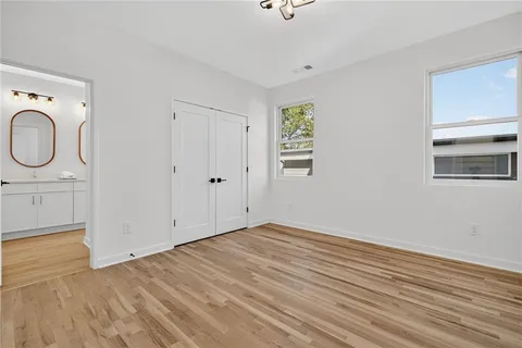 a view of a room with wooden floor and window
