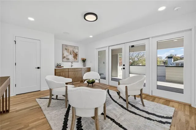 a living room with furniture a wooden floor and next to a window