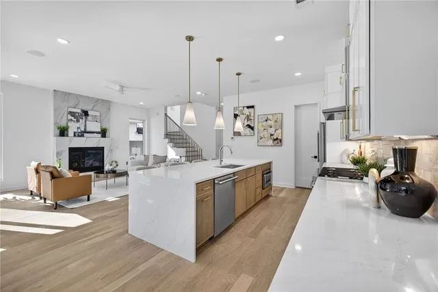 a large white kitchen with cabinets a sink and a couch