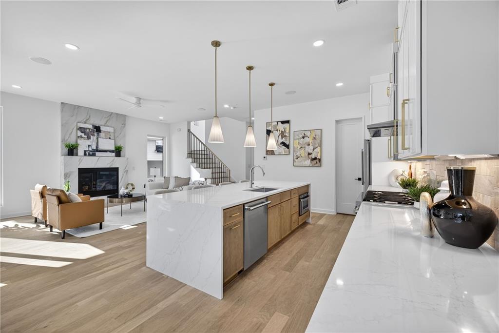 159 Walthall Street Southeast, Unit A Atlanta, GA 30316 - Photo 7 of 44 a large white kitchen with cabinets a sink and a couch