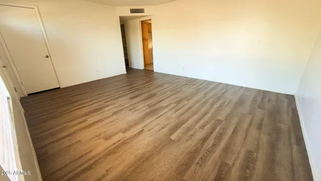 a view of a room with wooden floor