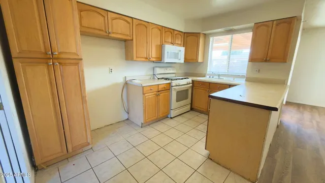 a kitchen with stainless steel appliances a refrigerator sink and microwave