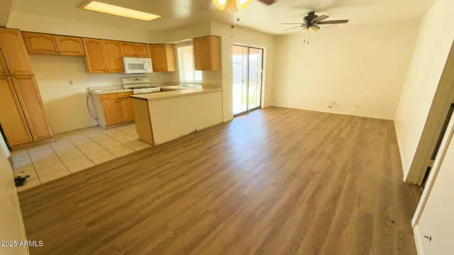 a view of a kitchen with wooden floor and a sink