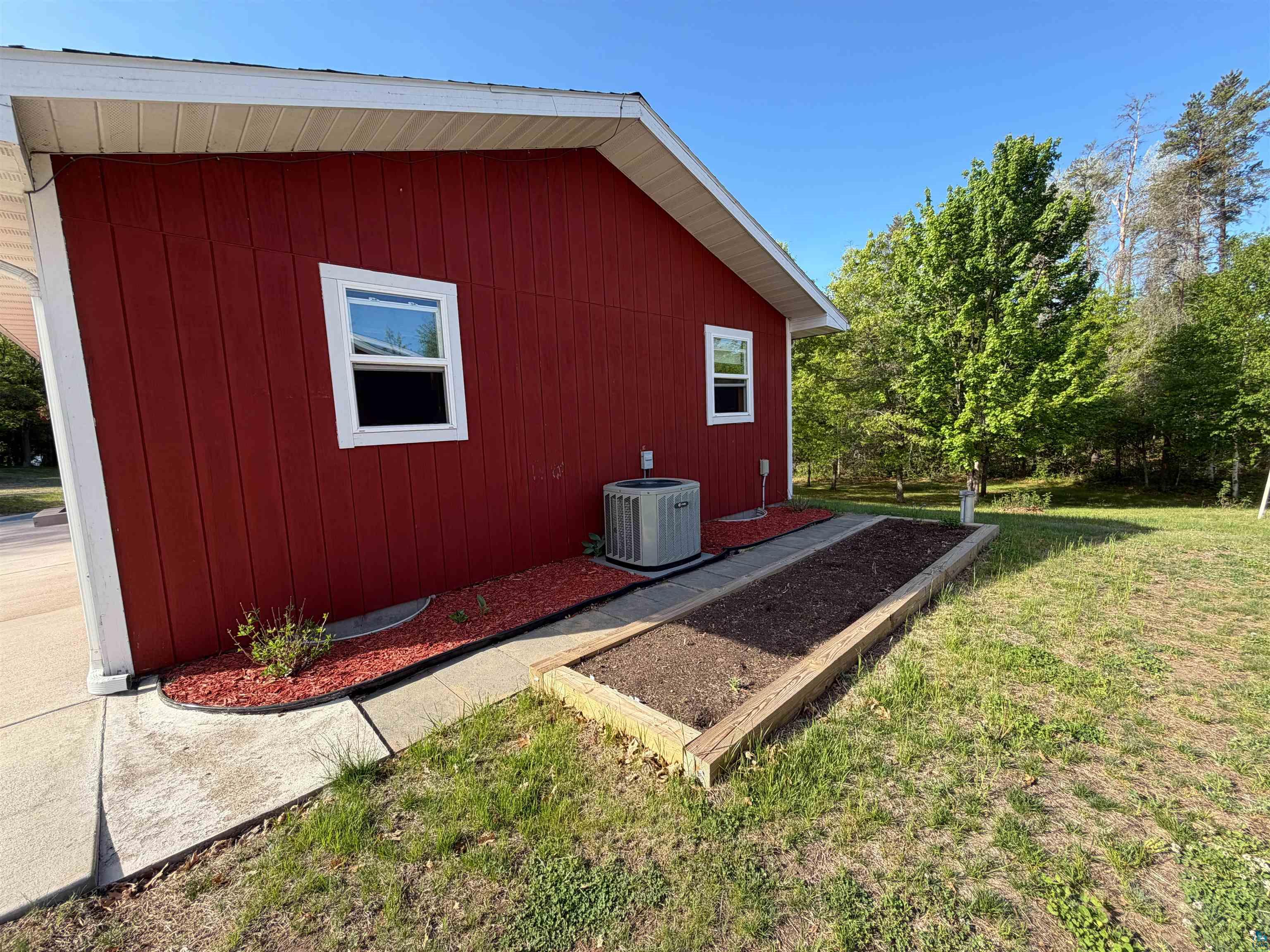 11702 East Mail Road Gordon, WI 54838 - Photo 56 of 60 Red vertical siding exterior with white trim and windows