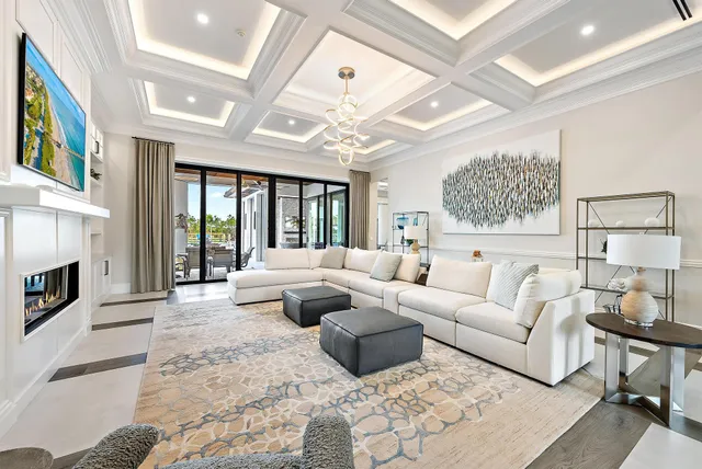 a dining room with furniture and a large window