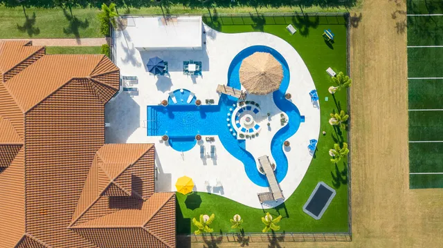 a view of swimming pool with a patio and couches