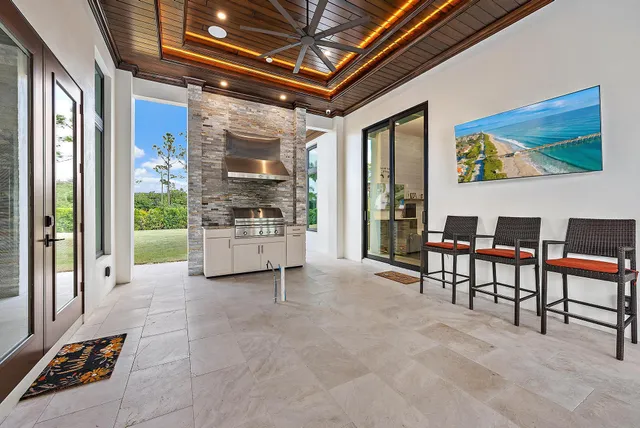 a front view of a house with swimming pool garden and patio