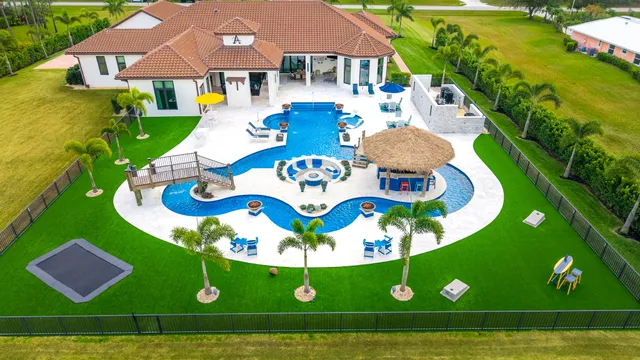 a view of a hallway with wooden floor and a living room