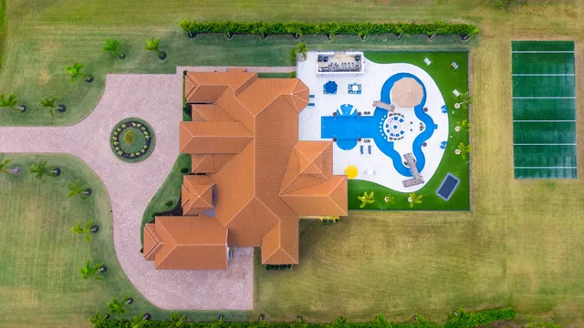 a living room with furniture fireplace and a large window