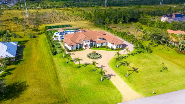 a living room with furniture large window and a fireplace