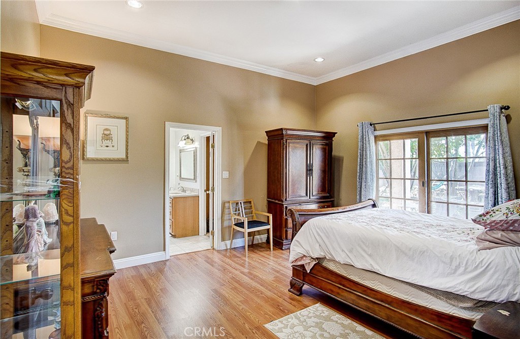 18329 Ambler Avenue Carson, CA 90746 - Photo 16 of 33 a bedroom with a bed and wooden floor