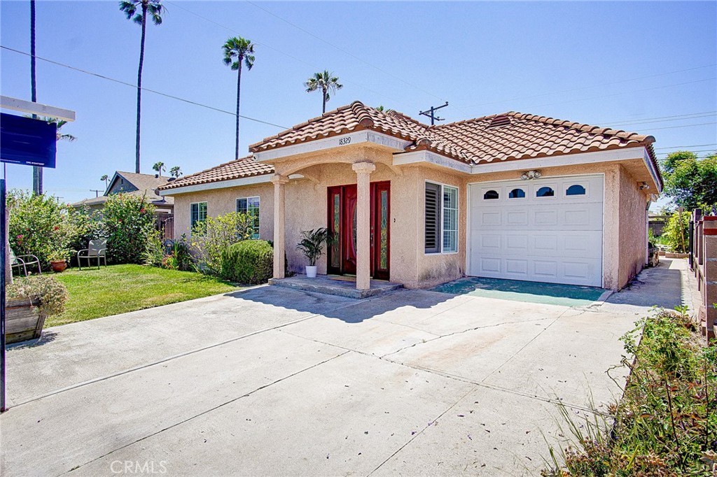 18329 Ambler Avenue Carson, CA 90746 - Photo 4 of 33 a front view of a house with garden