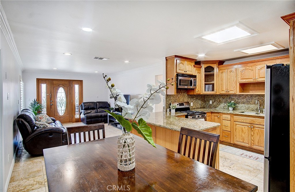 18329 Ambler Avenue Carson, CA 90746 - Photo 7 of 33 a view of a dining room with furniture a kitchen and chandelier