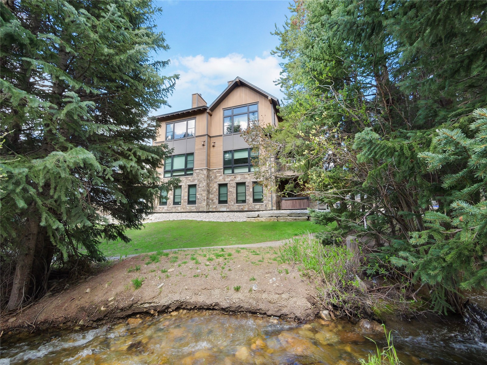 75 Alcove Court, Unit 75 Keystone, CO 80435 - Photo 2 of 40 a view of a big yard in front of a house with large trees