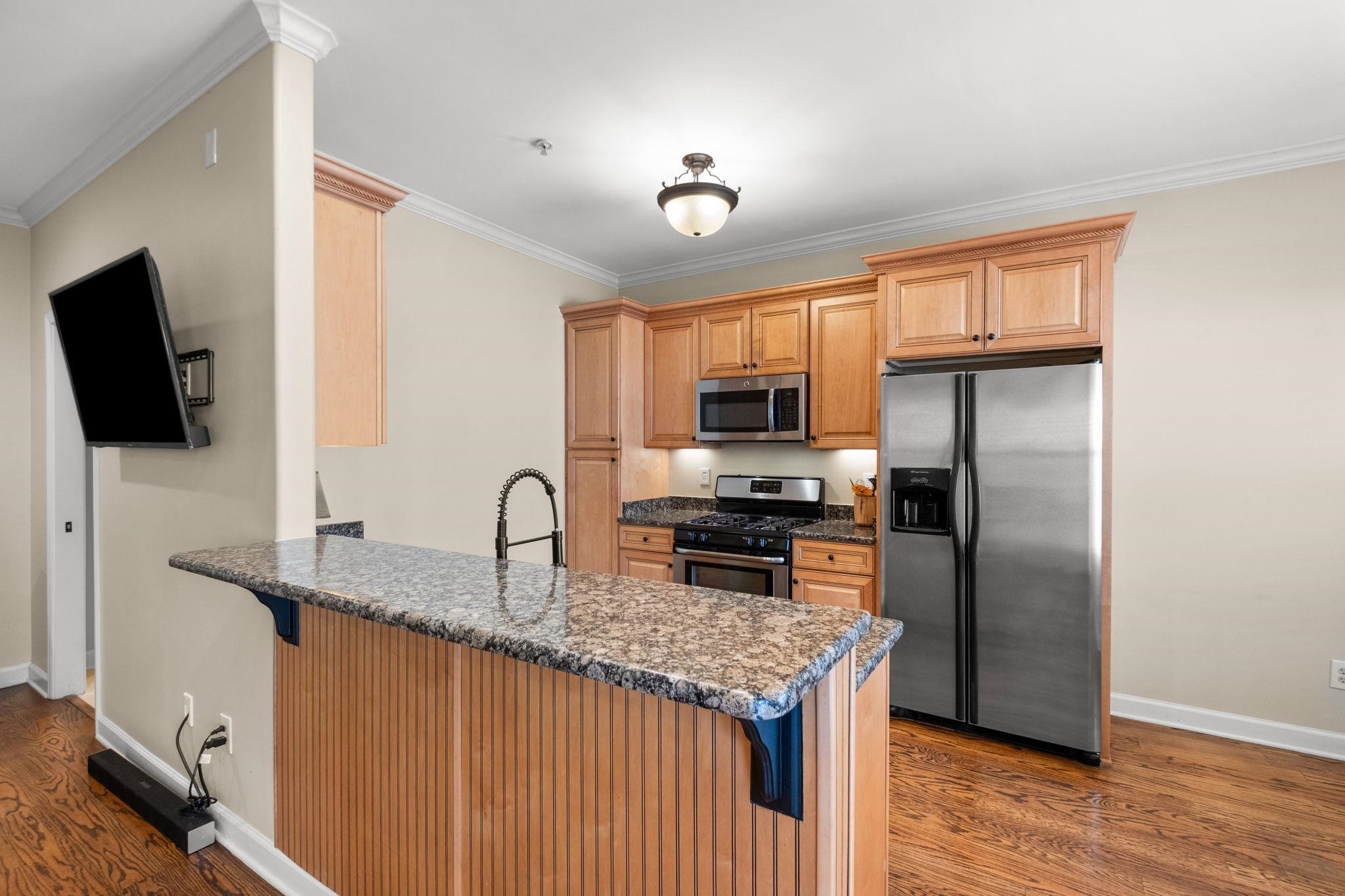 2275 McVay Road, Unit 2275 Germantown, TN 38138 - Photo 3 of 40 a kitchen with stainless steel appliances granite countertop a sink stove microwave and refrigerator