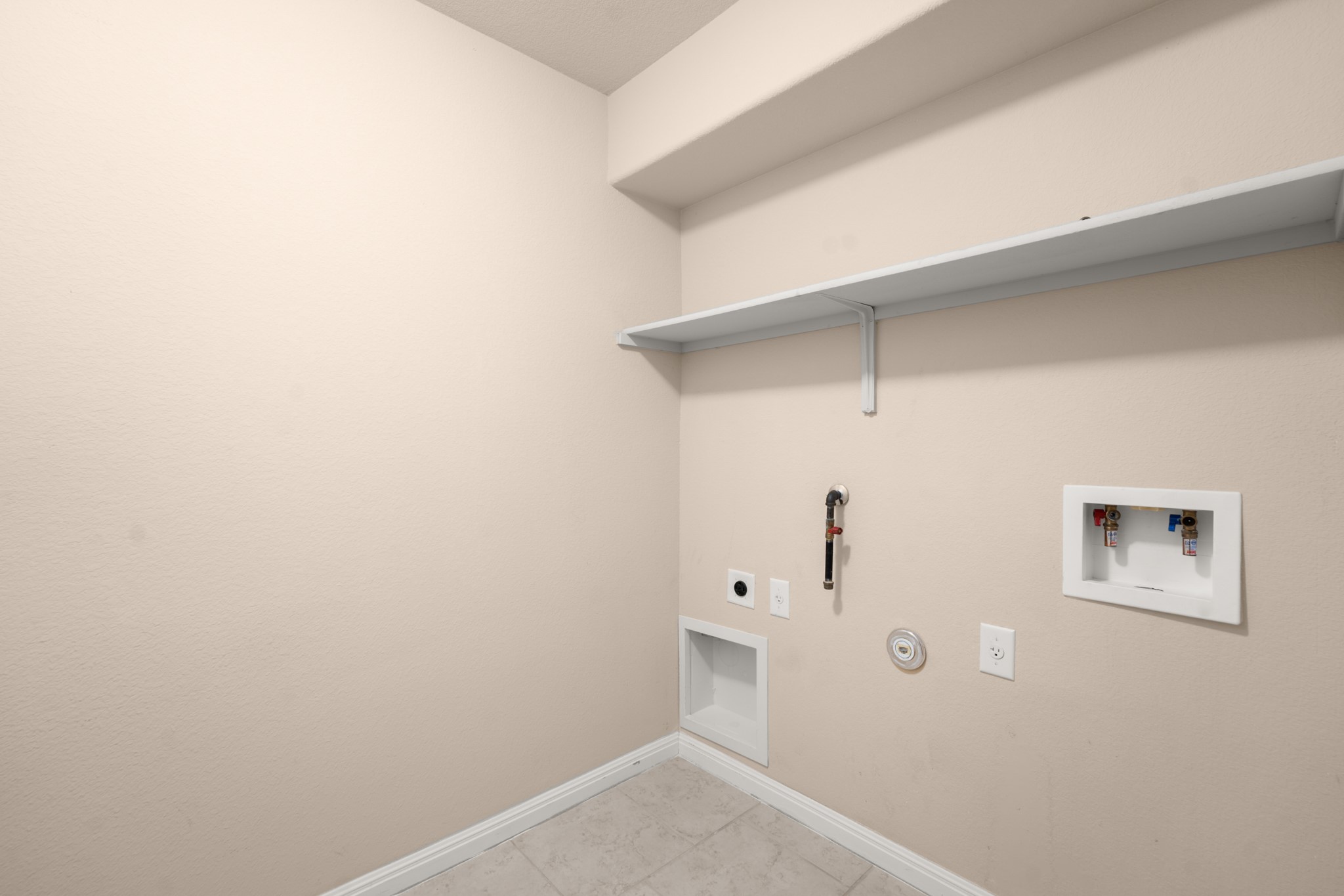 305 Longhorn Cavern Road Leander, TX 78641 - Photo 9 of 21 A dedicated laundry room with built-in shelving is a total game changer for keeping things organized.