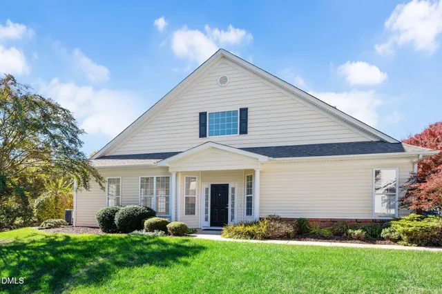 a front view of a house with a yard and porch