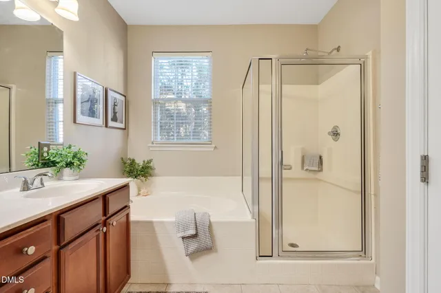 a bathroom with a tub shower and sink