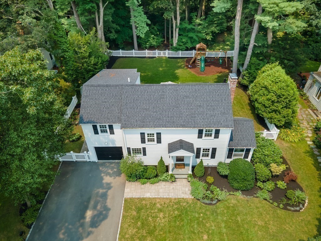 an aerial view of a house with swimming pool garden and patio