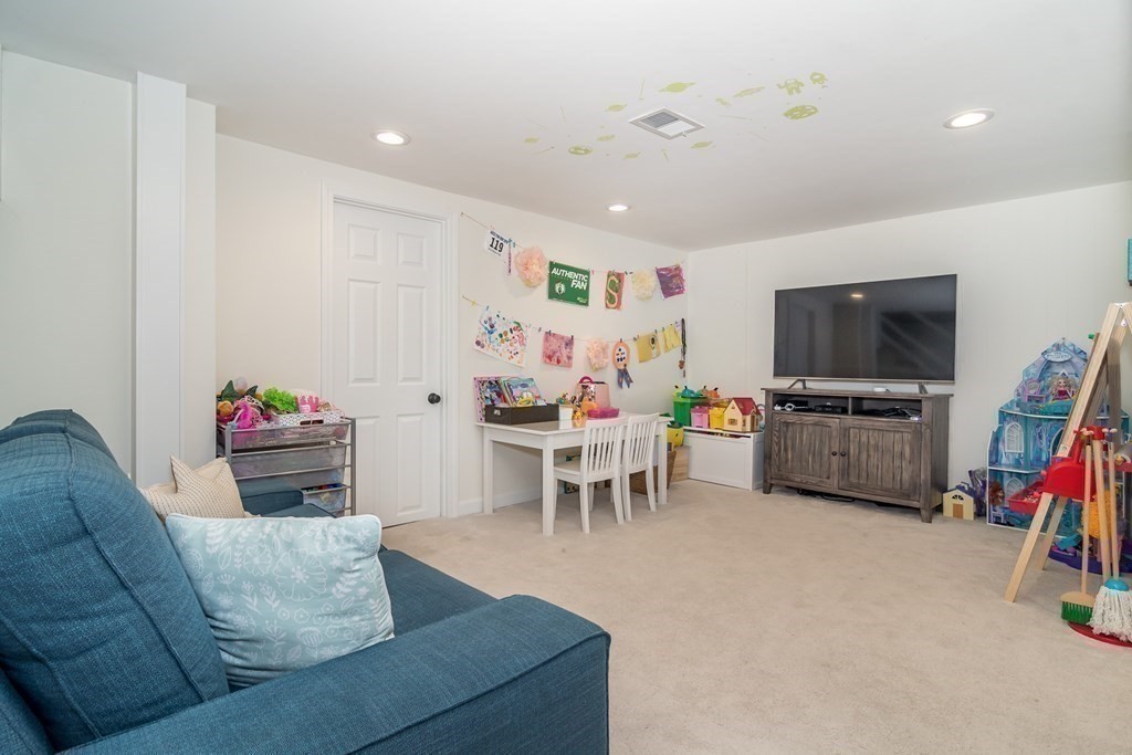 81 Parker Road Wellesley, MA 02482 - Photo 20 of 25 a living room with furniture and a flat screen tv