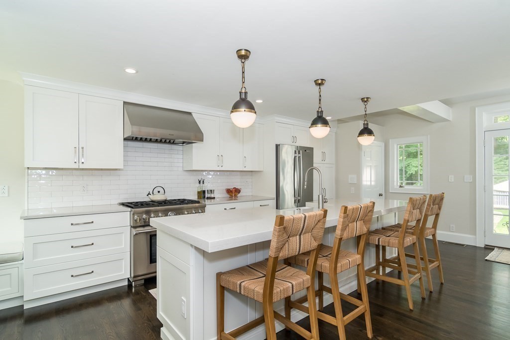 81 Parker Road Wellesley, MA 02482 - Photo 4 of 25 a kitchen with a stove a table and chairs