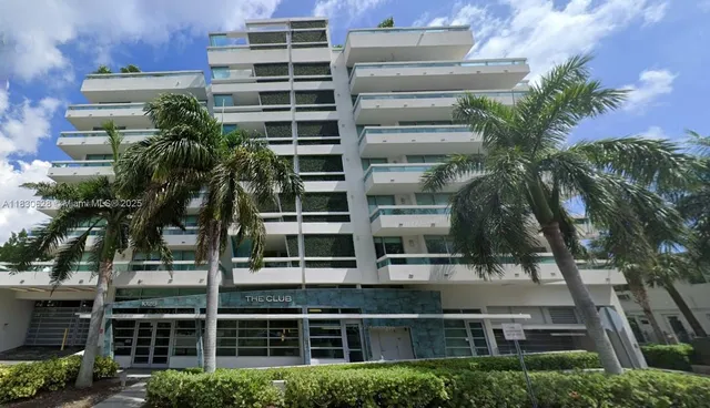 a front view of a multi story building with yard