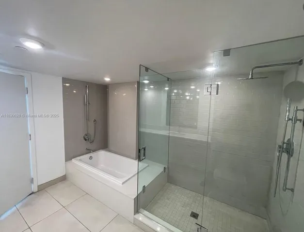 a bathroom with a bathtub and a shower
