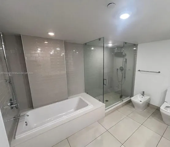 a bathroom with a bathtub and a shower