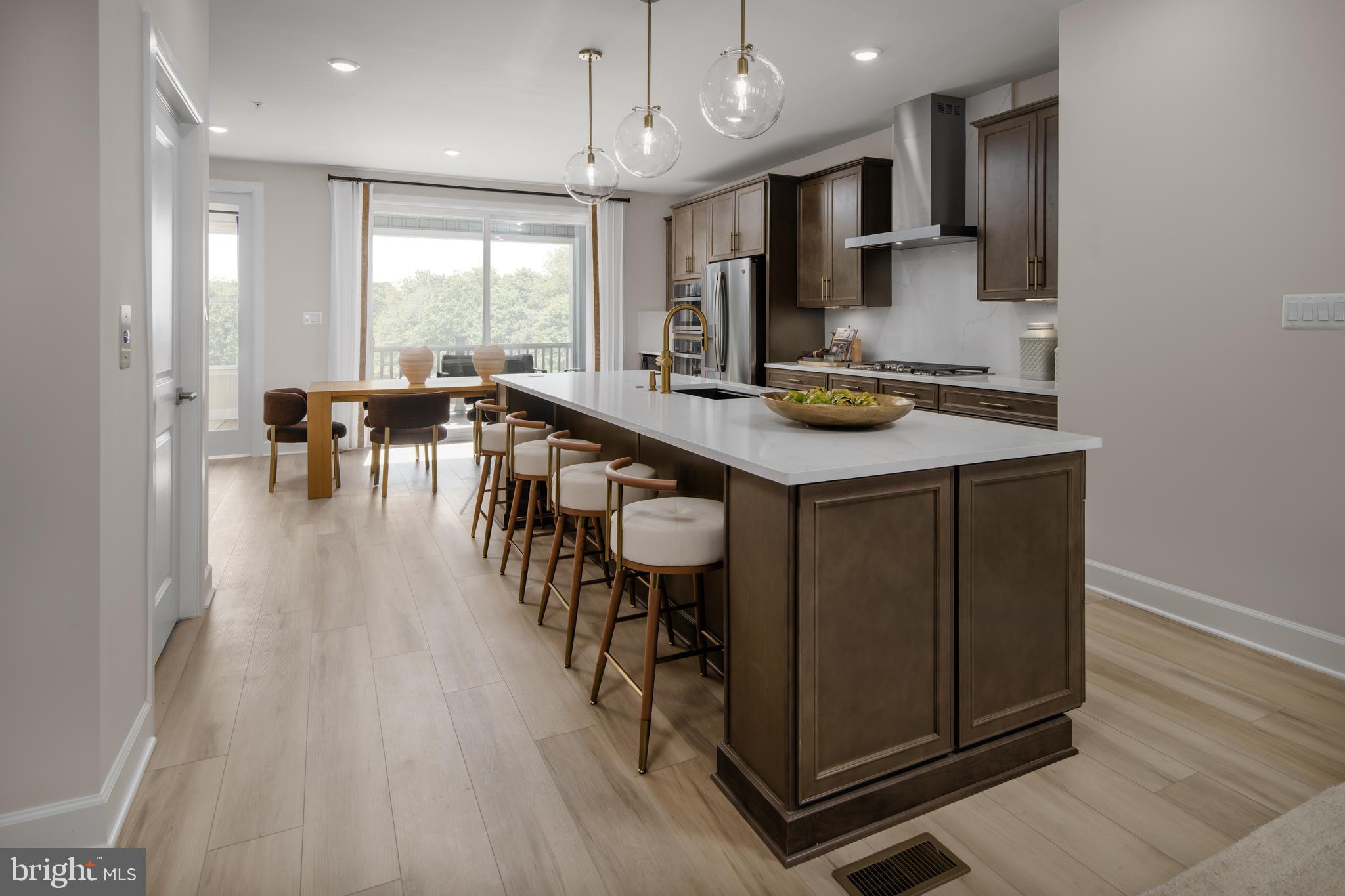 9406 Gerst Road Perry Hall, MD 21128 - Photo 7 of 22 a kitchen with stainless steel appliances granite countertop table chairs sink and cabinets