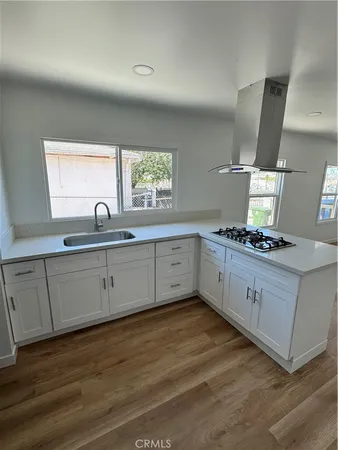 a kitchen with cabinets a sink and appliances