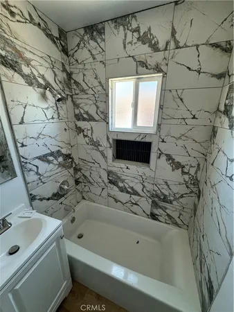 a bathroom with a sink a toilet and bathtub